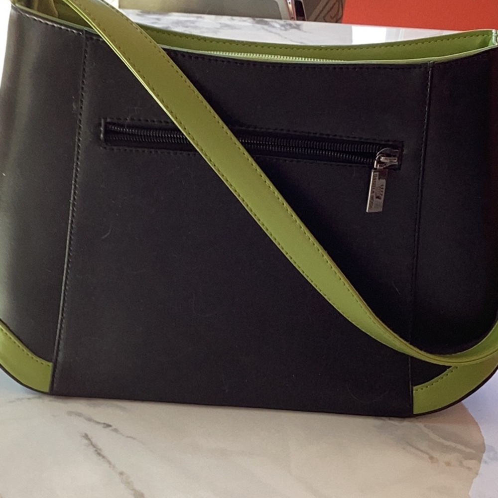 Black leather pocketbook, trimmed in green by Daniela Moda. Very clean, elegant